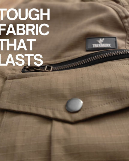 Khaki ripstop fabric with a zipper and button, featuring the Trekmonk brand logo.