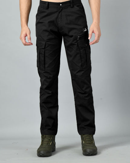 Trekmonk Black multiple pocket cargo pants worn by a person on a gray background