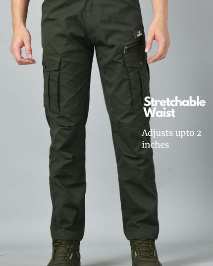 Olive green Trekmonk 7-Pocket cargo pants with a stretchable waist feature on a gray background