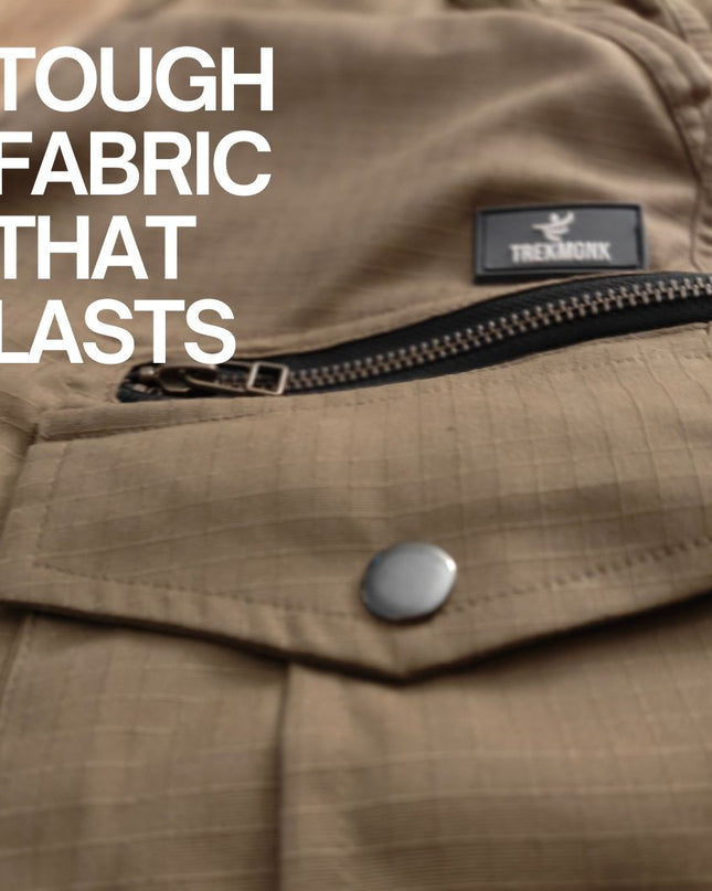 Khaki ripstop fabric with a zipper and button, featuring the Trekmonk brand logo.