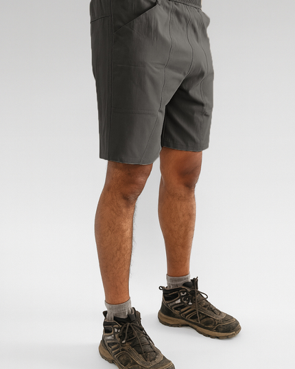 Person wearing Trekmonk gray shorts and hiking boots on a white background