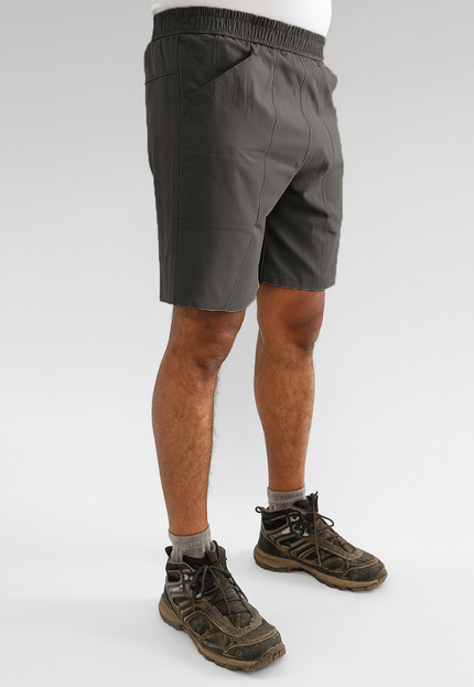 Person wearing Trekmonk gray shorts and hiking boots on a white background