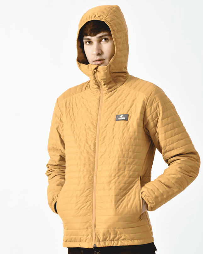 A person wearing a yellow Thermaloft upto zero degree mountaineering Jacket with a hood, designed for cold temperatures, displayed against a plain background.