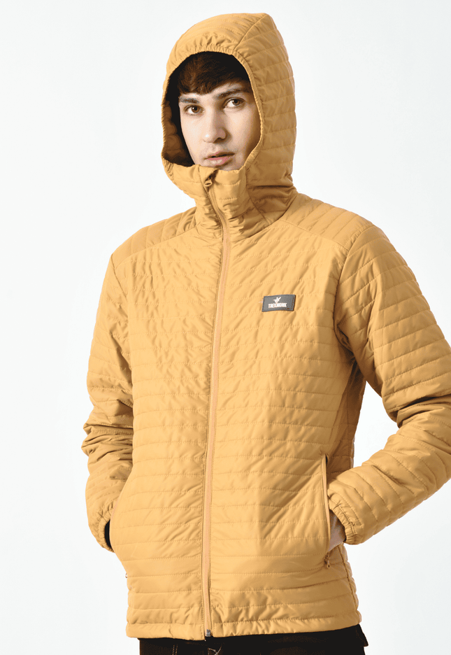 A person wearing a yellow Thermaloft upto zero degree mountaineering Jacket with a hood, designed for cold temperatures, displayed against a plain background.