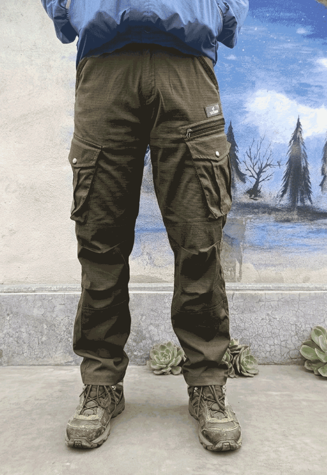 Person wearing green cargo pants with a wall background