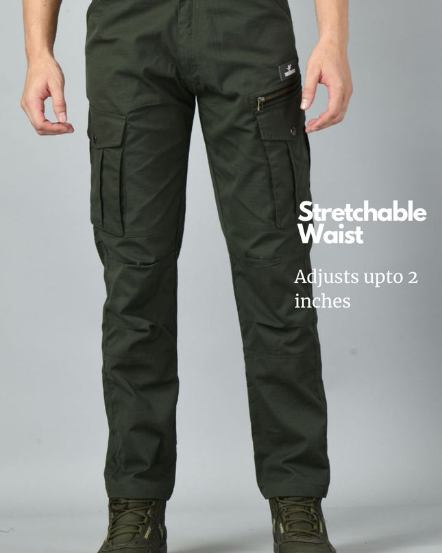 Olive green Trekmonk 7-Pocket cargo pants with a stretchable waist feature on a gray background
