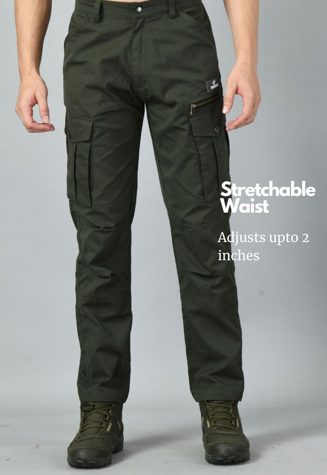 Olive green Trekmonk 7-Pocket cargo pants with a stretchable waist feature on a gray background